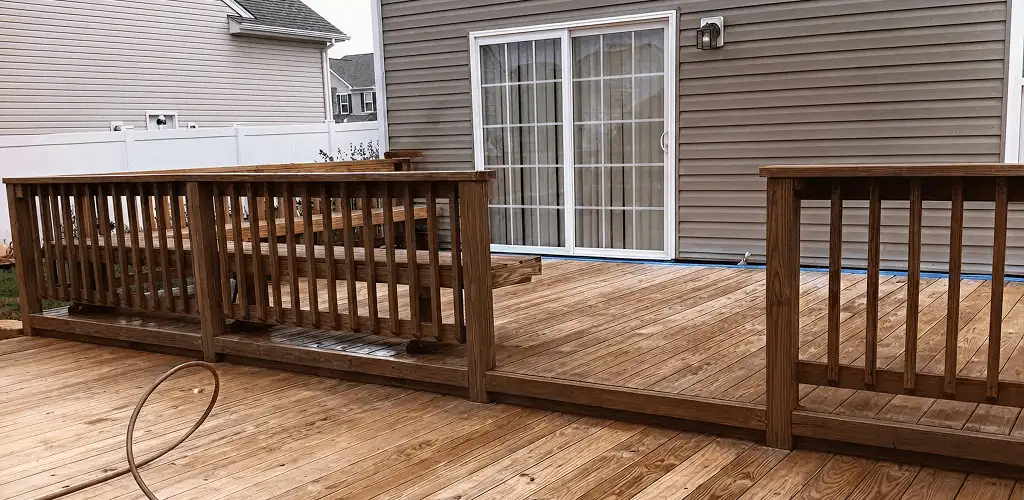 Deck sealing service protecting a backyard wood deck and railings in Overland Park, KS