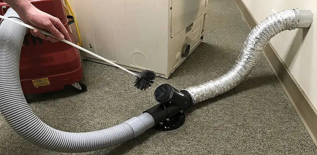 Dryer vent cleaning service removing lint from a dryer duct connection in Overland Park, KS